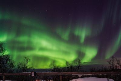 Scenic view of snowy field against sky at night during winter