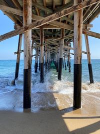 Wooden posts on beach