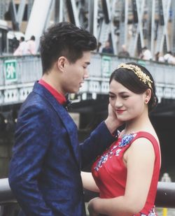 Side view of young couple standing outdoors