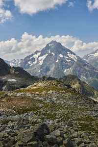 Scenic view of mountains against cloudy sky