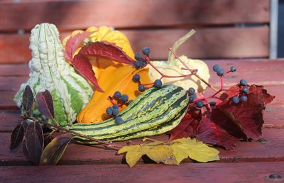 Colourful pumpkins and leaves on a table in autumn 