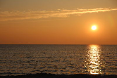 Scenic view of sea against orange sky