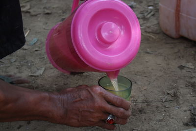 High angle view of hand holding drink