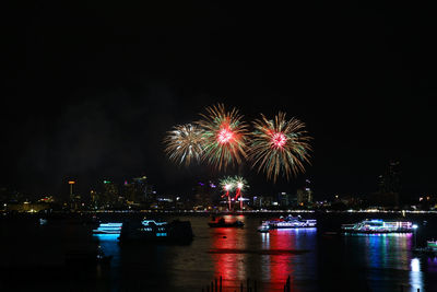 Firework display over river at night