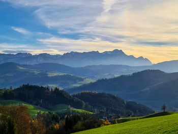 Scenic view of landscape and mountains against sky