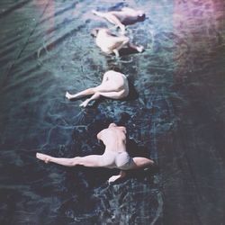 High angle view of baby swimming in lake