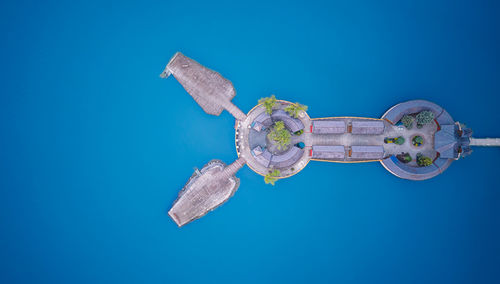Directly above shot of key against blue background
