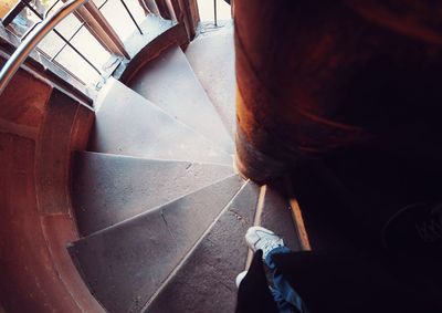 Low section of woman standing on staircase