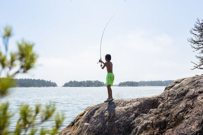 Boy fishing at lake