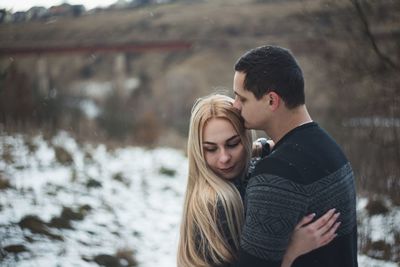 Side view of couple during winter