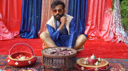 Full length of man sitting on table