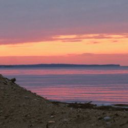 Scenic view of sea against romantic sky at sunset