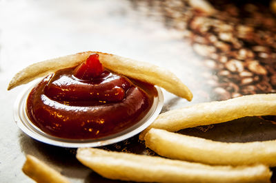 Close-up of french fries with sauce on table