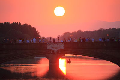 Bridge over lake against sky during sunset