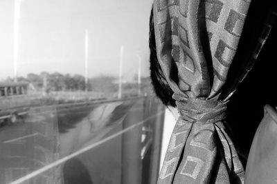 Close-up of boy by curtain traveling in bus