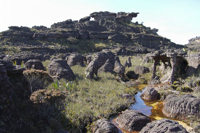 View of rock formation on landscape against sky