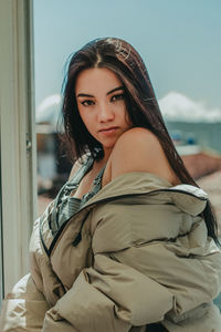 Portrait of young woman sitting outdoors