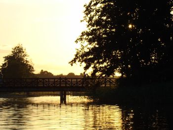 Scenic view of river at sunset