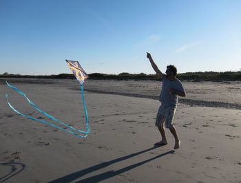 Full length of woman standing on beach