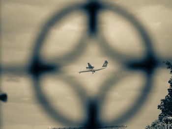 Low angle view of airplane flying against sky