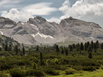 Scenic view of mountains against cloudy sky