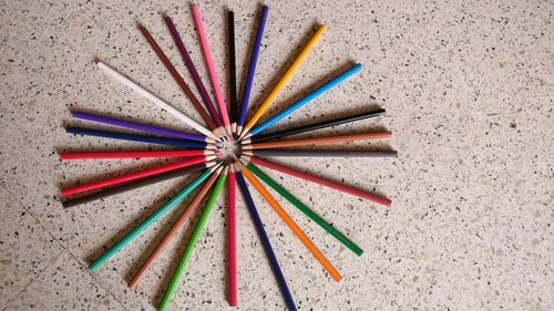 Directly above shot of colored pencils arranged on floor