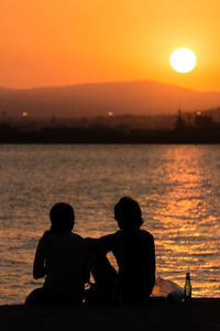 Rear view of young couple looking at sunset