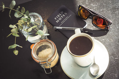 Close-up of coffee by sunglasses on table