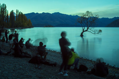 Calm lake with mountains in background