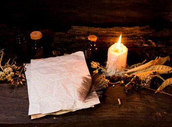 Close-up of burning candles on wooden table