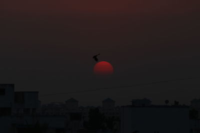 Silhouette buildings against sky during sunset