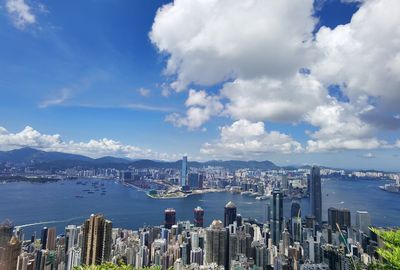 Panoramic view of city by sea against sky