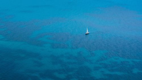 Aerial view of sailboat on sea against sky