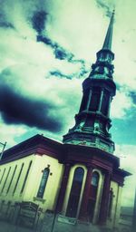 Low angle view of building against cloudy sky