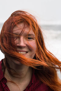 Close up happy lady with red hair waving in wind portrait picture