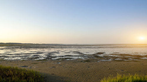 Scenic view of sea against clear sky during sunset