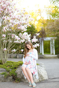 Full length of woman against pink flowering tree