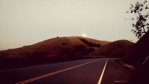 Country road leading towards mountains