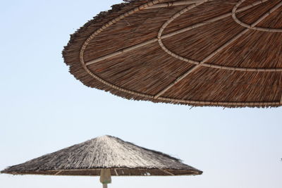 Low angle view of parasol against clear sky