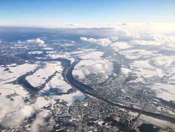 Aerial view of snowcapped landscape against sky