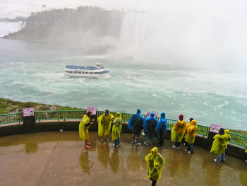 High angle view of people looking at waterfall