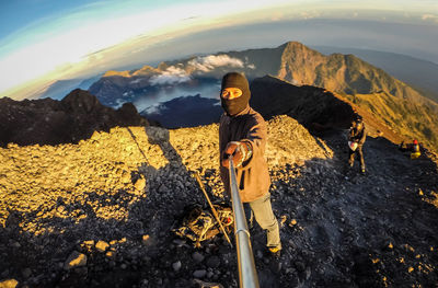 Man clicking selfie while standing on mountain