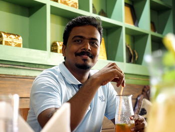 Portrait of smiling man sitting in restaurant