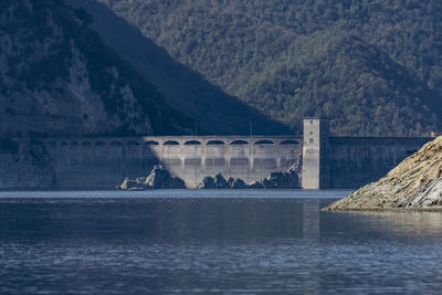 Bridge over river against mountain