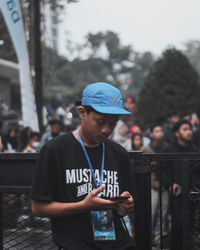 Side view of young man standing outdoors