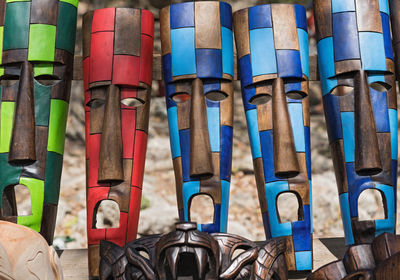 Colored wooden masks at a souvenir stand in chichen itza, yucatan, mexico