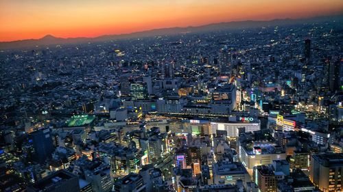 High angle view of illuminated cityscape against sky