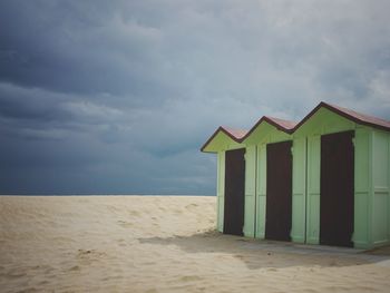 Lifeguard hut on beach against sky