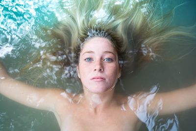 Portrait of young woman in swimming pool