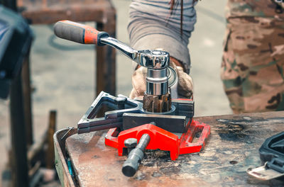 Low section of man repairing bicycle